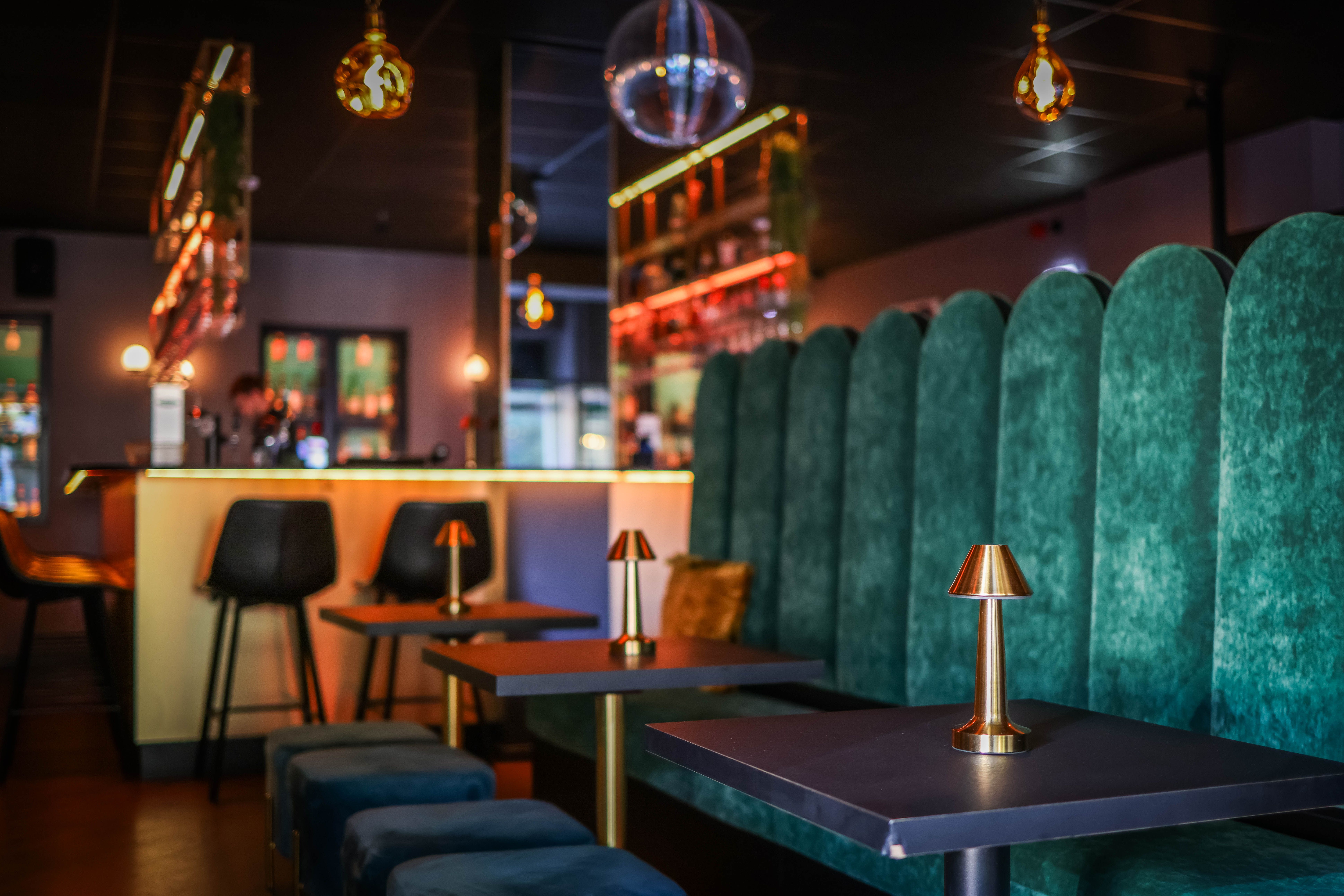 Sophisticated nightclub lounge with velvet seating, ambient lighting, and contemporary design.